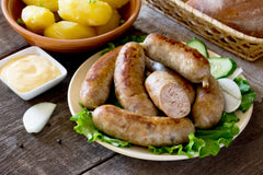 bratwurst sausage, vegetables, herbs and boiled potatoes