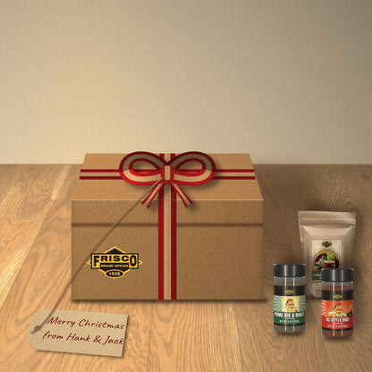 Hank's Grill Starter Gift Box: tied with a red and kraft ribbon on a wood table, with a 'Merry Christmas from Hank & Jack' tag