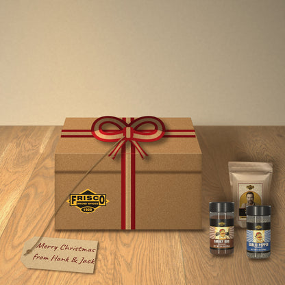 Jack's Smokehouse Gift Box: tied with a red and kraft ribbon on a wood table, with a 'Merry Christmas from Hank & Jack' tag