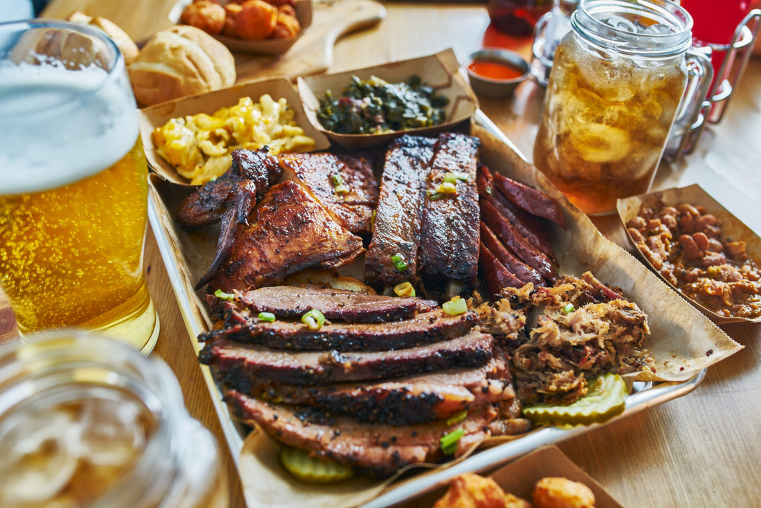 Tray of sliced smoked brisket, ribs and sides